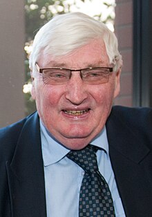 portrait photo of an old man wearing glasses