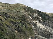 Predator-proof fence ending on a cliff face