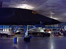 The nose section of a B-1A on display with outline of the ejection capsule denoted