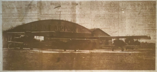 Old newspaper photo of an airport hangar