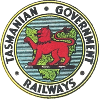 Logo of the Tasmanian Government Railways, showing the Tasmanian Red Lion on a Map of Tasmania, surrounded by Tasmanian Government Railways text.