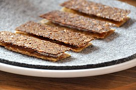 Rye bread and chicken skin with rygeost (Danish smoked cheese) and lumpfish roe