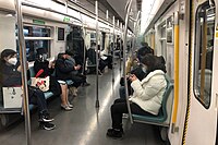 Passengers wear masks and maintain social distancing on a Line 4 train on March 23, 2020.