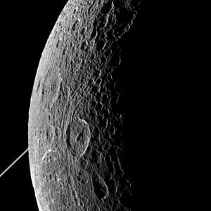 Dione in front of the rings of Saturn