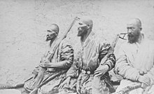 Photo of three bearded, armed men