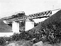 A private-owned Dutch East Indies Railways train crosses a railway bridge over the Code River (pronounced: [tʃo:ɖe]) in Yogyakarta on the line between Semarang to the "Vorstenlanden" or Royal Lands of the Surakarta Sunanate and the Sultanate of Jogjakarta