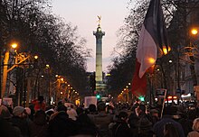 Place de la République statue column with large French flag