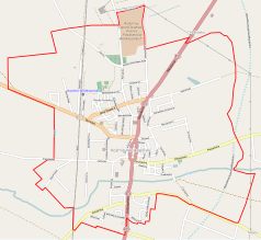 Mapa konturowa Koźmina Wielkopolskiego, blisko centrum na lewo u góry znajduje się punkt z opisem „Koźmin Wielkopolski”