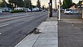 Image 42A patched road rut at a Portland Oregon bus stop. During the summer this part of the road will be hot and combined with a bus’s high ground pressure will compress and deform part of the road. Due to the lower elevation from the driveway, a large portion of the buses weight leans on one wheel causing damage to the road. Despite the repairs, you can see the patch is already damaged. This is all happens yearly. (from Road surface)