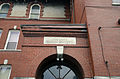 Inscription over door of former school at Saint Adalbert Basilica: "Come, Holy Spirit."