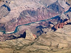 View below Comanche Point (Desert View region), East Rim. A 3-mile stretch of the Colorado River from Lava Creek, with Lava Butte, of Cardenas Basalt, and river flowing southwest, to just north of Basalt Creek (in the Dox Formation, underlying the Cardenas Basalt). (Tanner Graben at Tanner Rapid at bottom-left.)