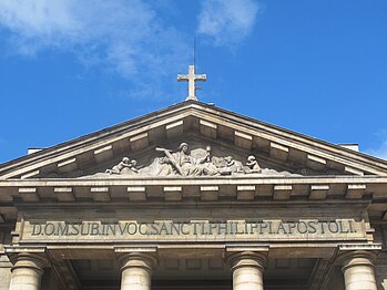 The sculpture on the pediment depicts "Religion", holding a chalice and a cross.