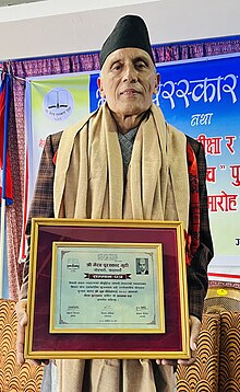 Moon Poudel receiving the Bhairab Puraskar for 2080 BS in a function at Kathmandu, Nepal.