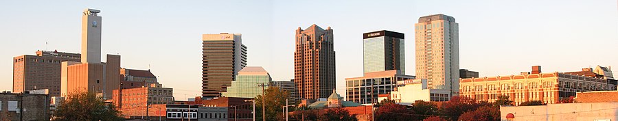 Panoramic view of a city's skyline. In the distance, there is a city skyline with several skyscrapers of varying heights.