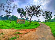 A view of a sign board on the entrance road of KSGM College Nirsa