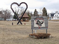 Sign and sculpture entering McClusky on Highway 200