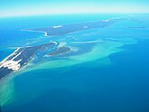 Moreton Island and North Stradbroke Island form a barrier that protects Moreton Bay.