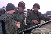 Russian soldiers (left) speak to an officer of the U.S. 1st Division, 1996