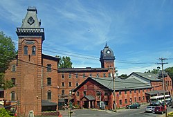 The mill complex, with four brick buildings and two towers.