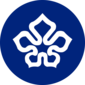 A blue circular emblem with a white 5-petalled flower design in the center