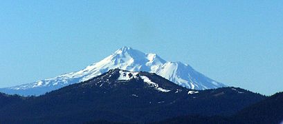 An aerial image of Mount Ashland with Mount Shasta behind it