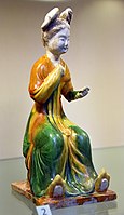 Woman holding a mirror. Earthenware with 3-colored (sancai) glaze. Tang dynasty, 700-750 CE. From the Eumorfopoulos Collection. Victoria and Albert Museum, London