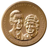 Gold medal with the heads of a man and a woman