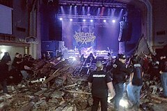 Concertgoers attempt to remove debris burying multiple audience members