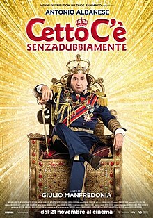 Poster for the film Cetto C'è Senzadubbiamente featuring Antonio Albanese dressed in an extravagant royal military uniform, sitting on an ornate golden throne. He wears a large crown and holds a scepter, with a smug expression. The background is filled with radiant golden light, and the film title is prominently displayed in bold red letters at the top.