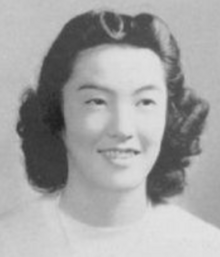 A young Japanese woman with dark wavy hair, smiling