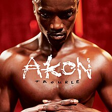 A shirtless man with the name “AKON” written below as well as “Trouble” being written below too.