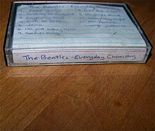 A cassette tape with the words "The Beatles-Everyday Chemistry" and the tracklist of the album written on a cutout piece of ruled paper.