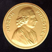 Photograph of a gold medal, which says „Joseph Priestley” around the edge and has a profile of a man stamped in the center