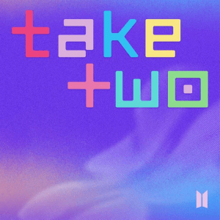 Bìa có chữ "Take Two" được viết theo kiểu pixel hóa bằng chữ thường trên nền cầu vồng với logo nghệ sĩ ở dưới cùng bên phải